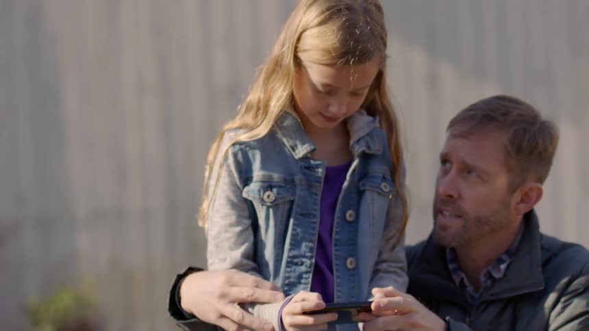 Man helps girl fly a drone