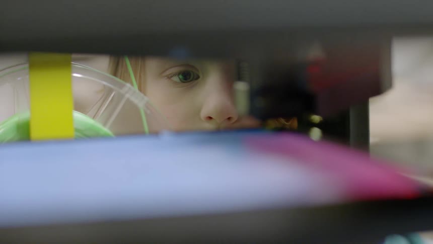 A child watches a machine at work