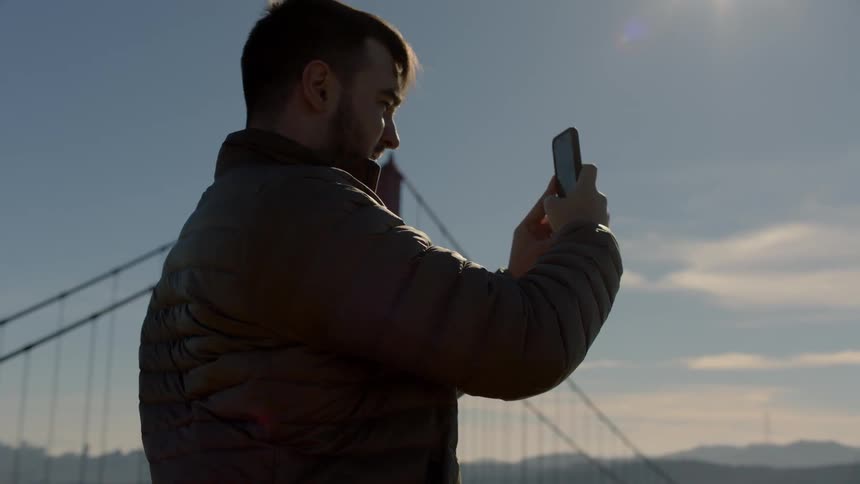 Man takes photograph of golden gate bridge