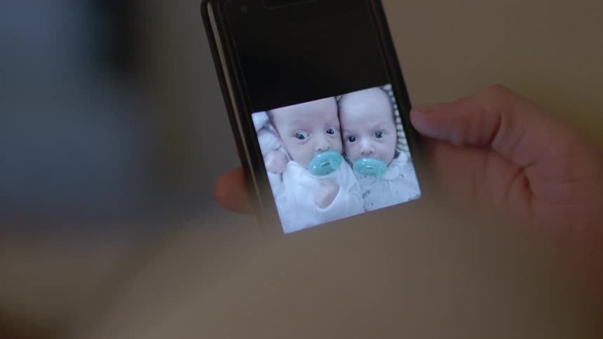A person looks at pictures of babies