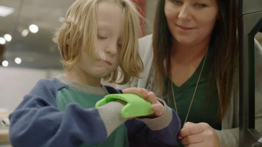 Woman teaches child at school