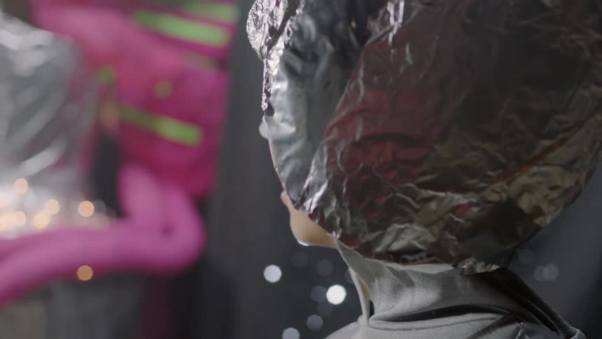 A boy is wearing a tin foil hat