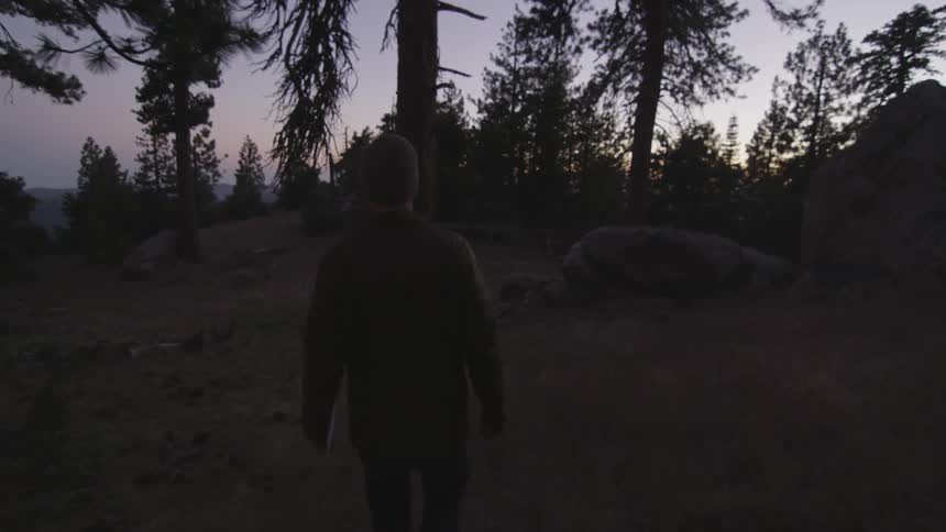 Person walking downhill as the sunsets