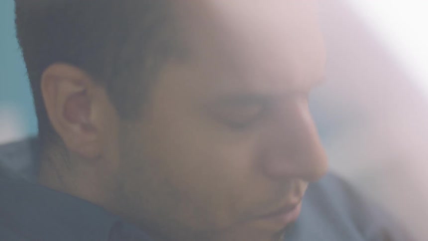 Man with eyes closed against bright light