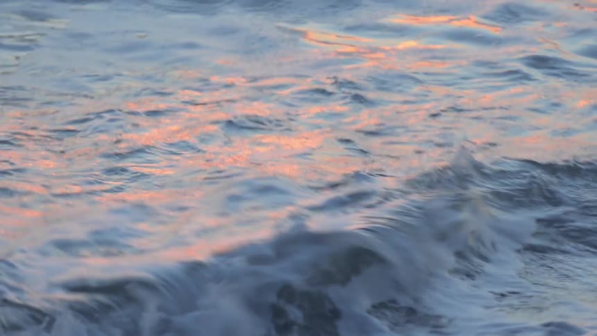 Water washes up onto a pebbled beach