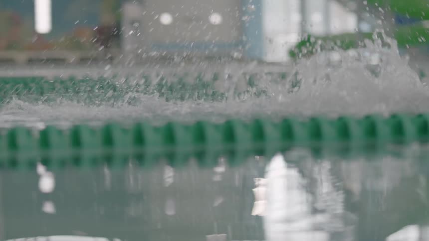A man swims in an indoor pool