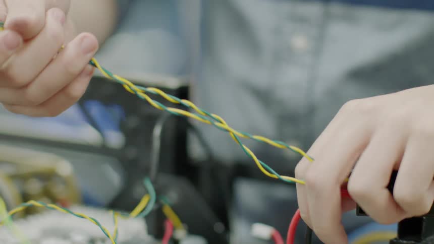 A person arranging wires