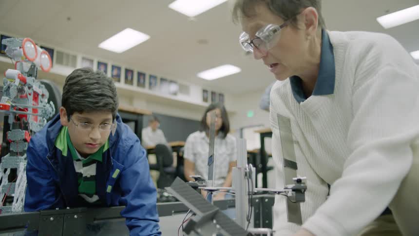 Woman describes a science experiment to a young boy