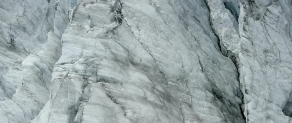 The tall iceberg has black dirt on top