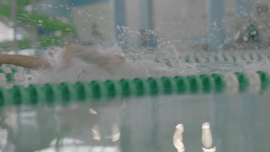 Someone is doing the breaststroke in a pool