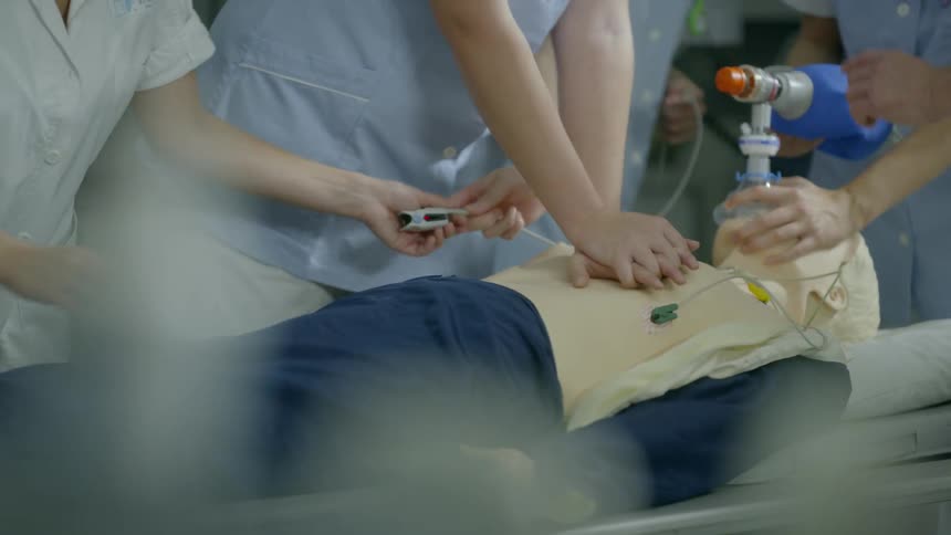 Students are learning how to perform cpr in a medical setting