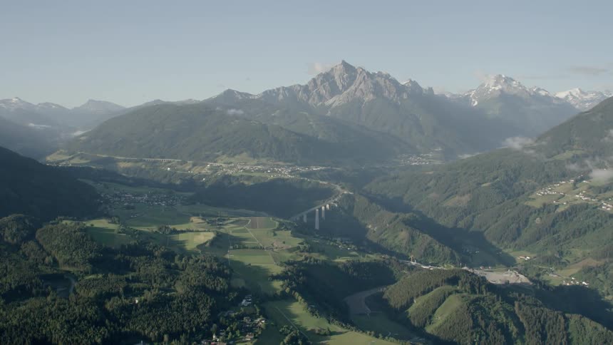 A forested valley near mountains
