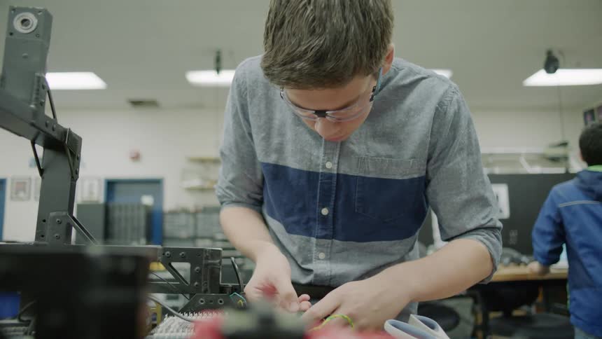 Student working on an electrical project in a class