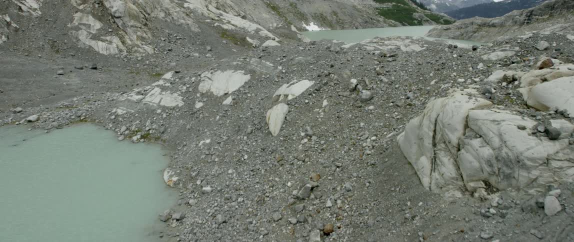 A rocky landscape surrounds a mountain lake