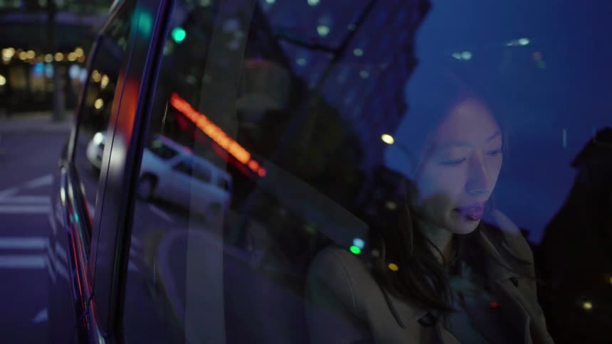 Woman sits in passenger seat of a moving vehicle