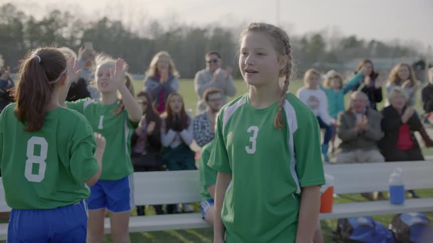 Soccer players high five during a game