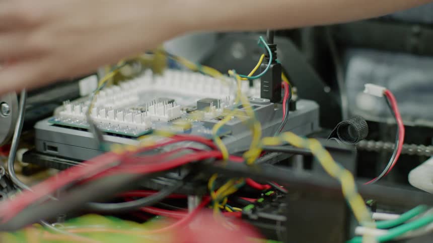 A man wires an electronics board