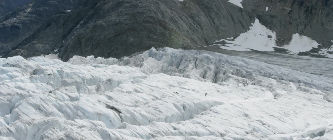 The field is covered with ice before the mountain