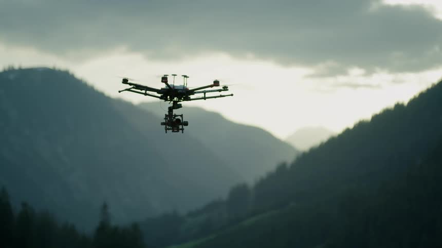 A drone hovers in the mountains
