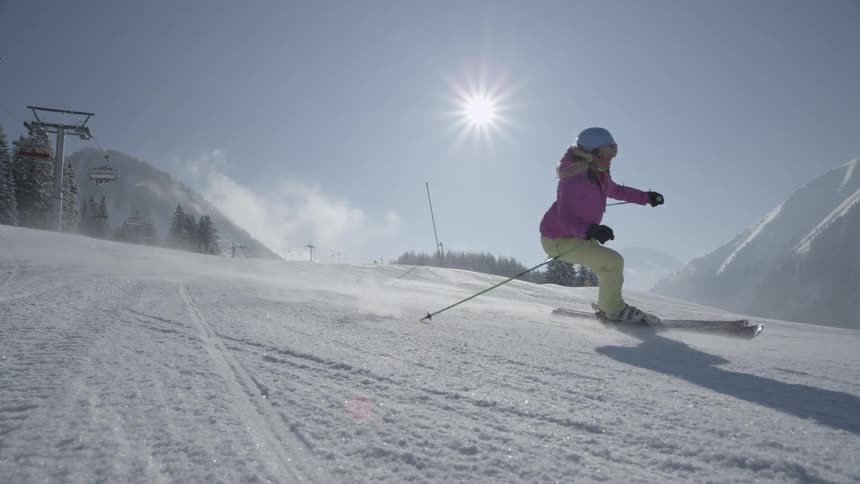 Skiers glide down a snowy mountainside