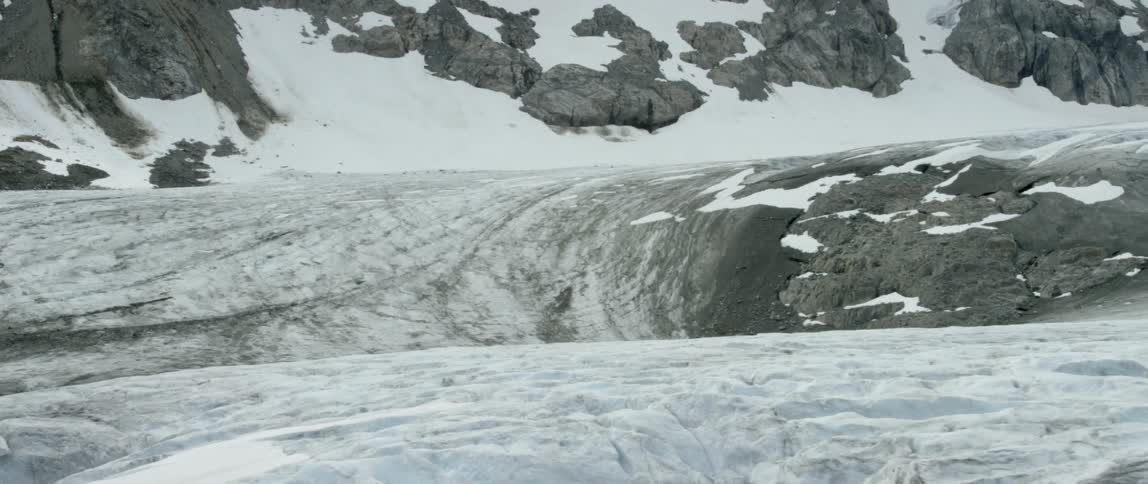 Snow covers a rocky mountainside