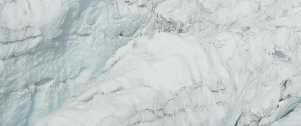 Piles of snow sit in the mountains