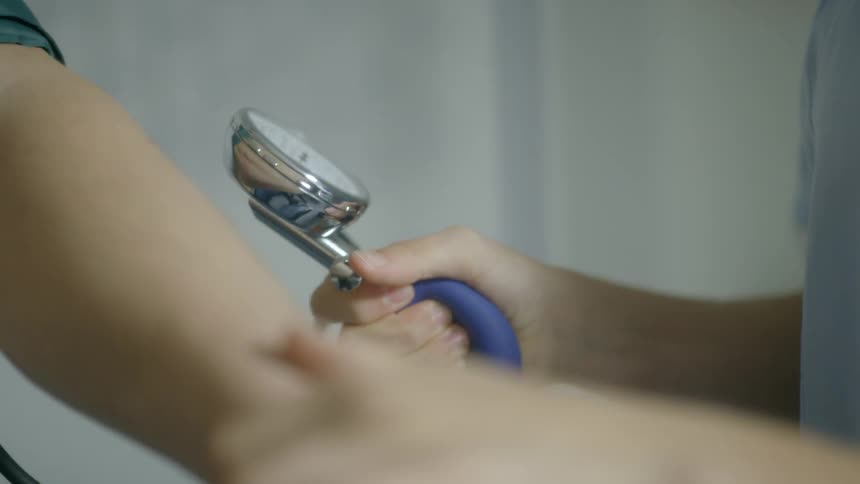 A nurse is taking a patient's blood pressure in a medical setting