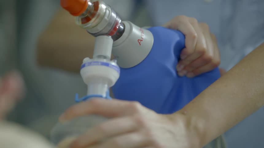 A nurse pumps an airbag