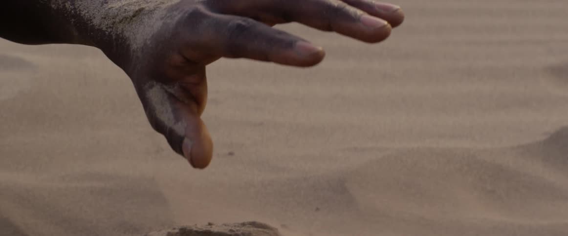 Someone is sticking their hand in hot sand