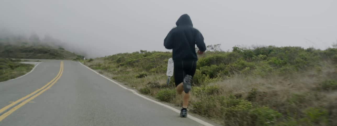 A man jogs on a rural road