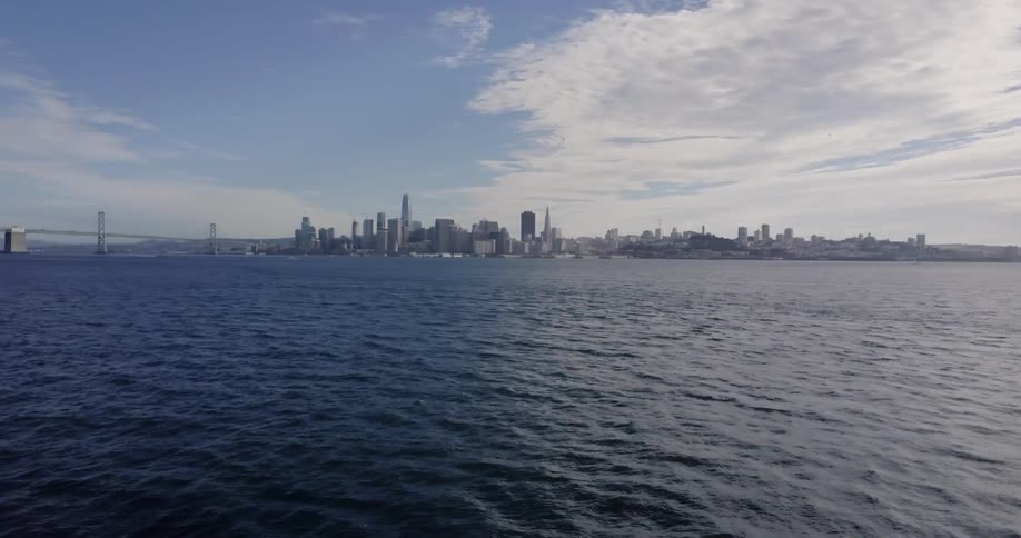 The tide flows towards a city on the shore