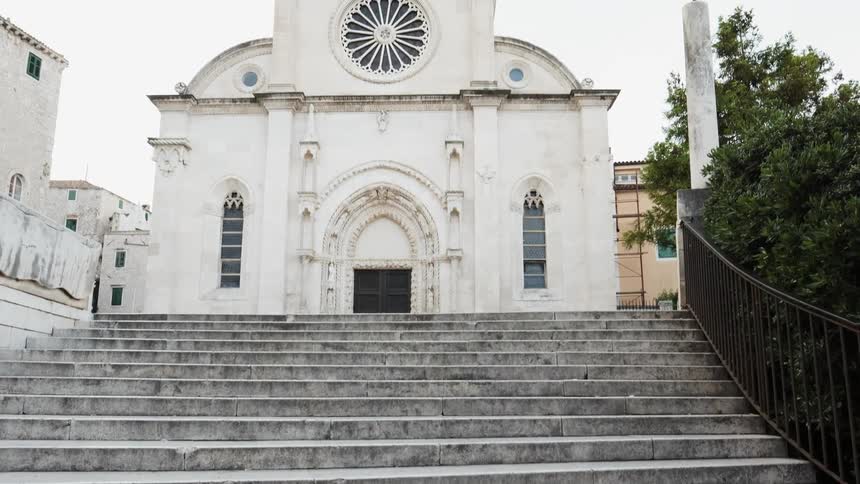 Concrete steps lead to a white building
