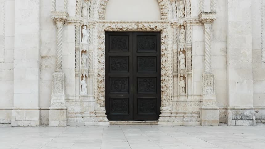 The large building has a big black door in front