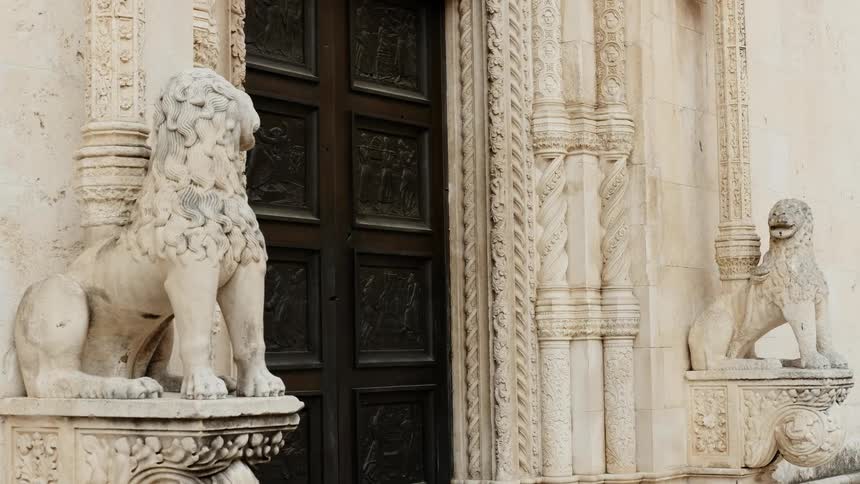 There are two statues of animals in front of the building