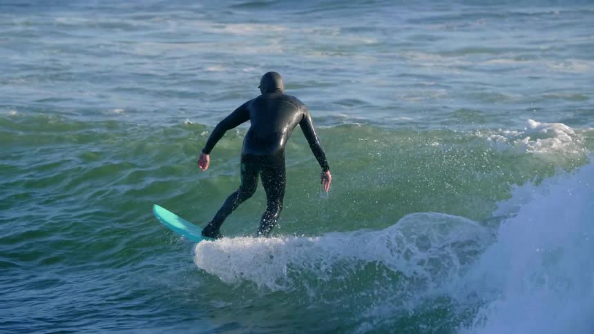Someone in a wet suit is surfing a wave
