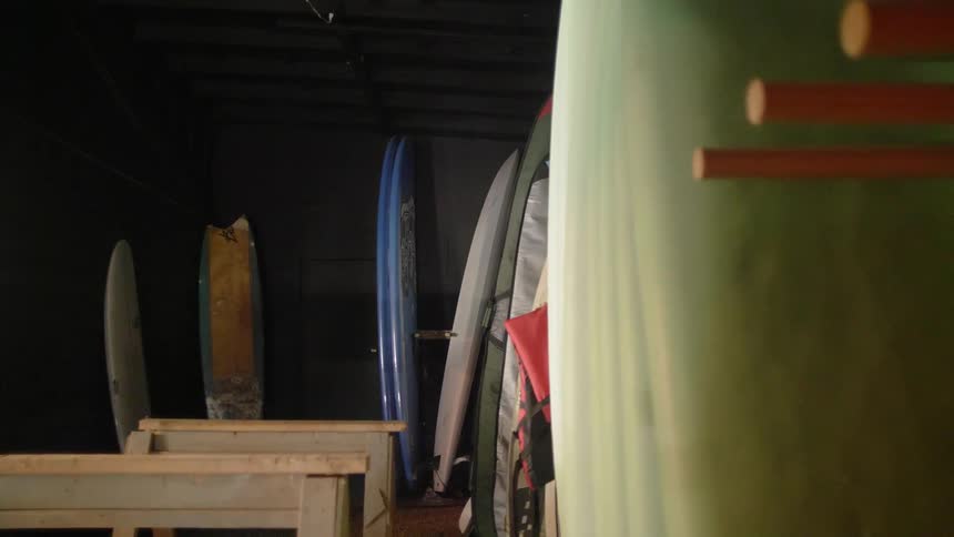 Surfboards are stored in a shed
