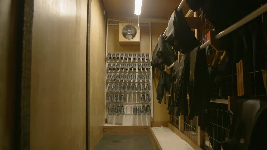 A locker room with shoes is shown
