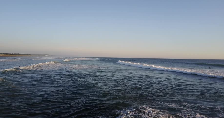 A surfer is pushed by incoming waves toward the shore