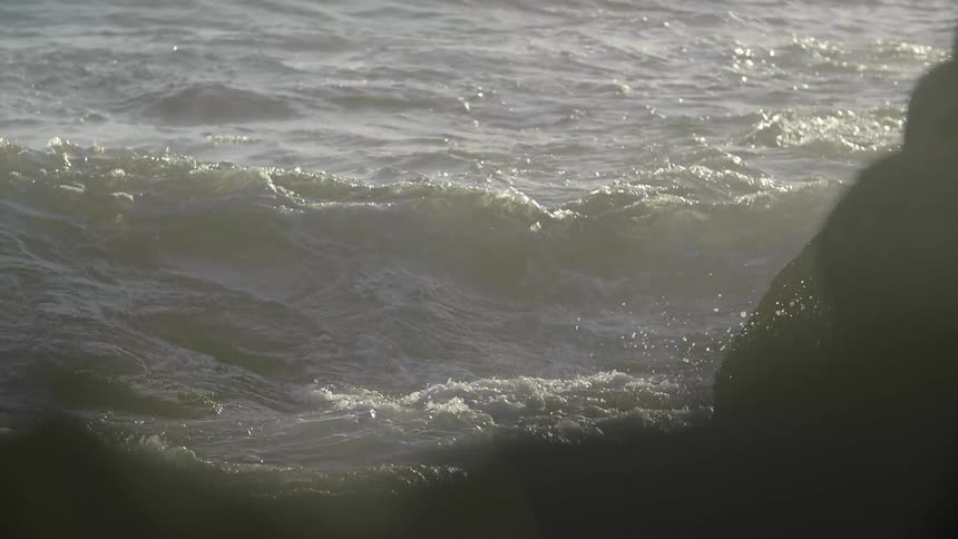 Ocean waves splashing on a sunny day