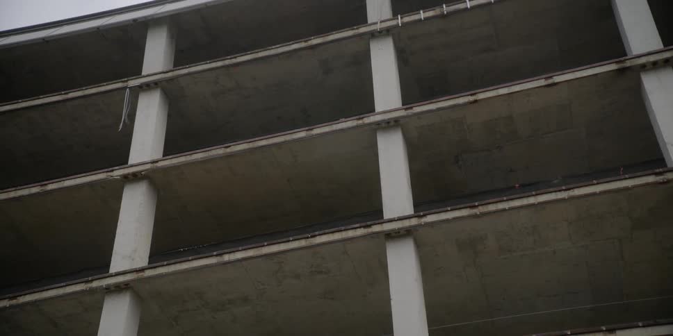 A parking garage is viewed from the street