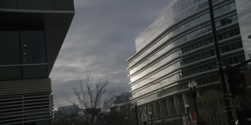 Storm clouds hover over office buildings during the day