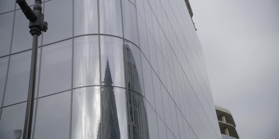 The building has a pole on the corner and a cloudy sky above