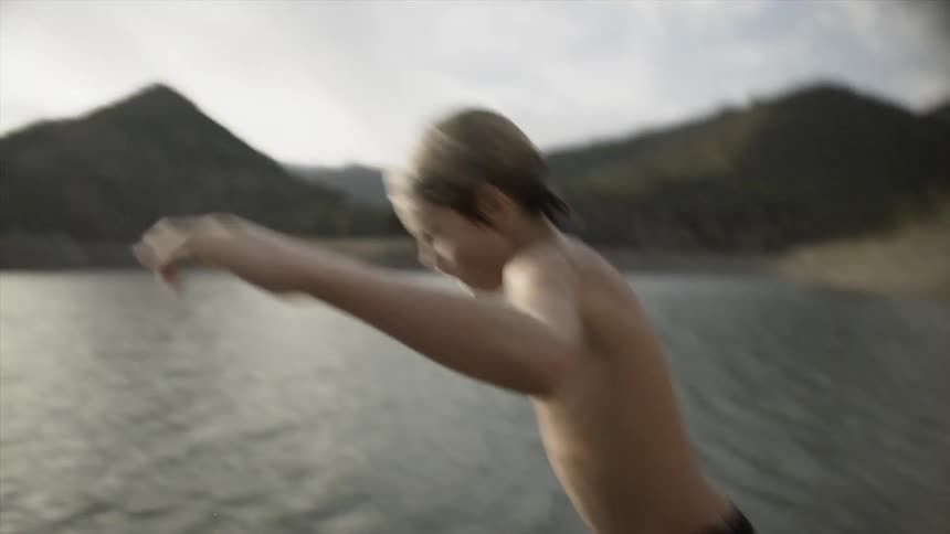 A young boy jumps into the water
