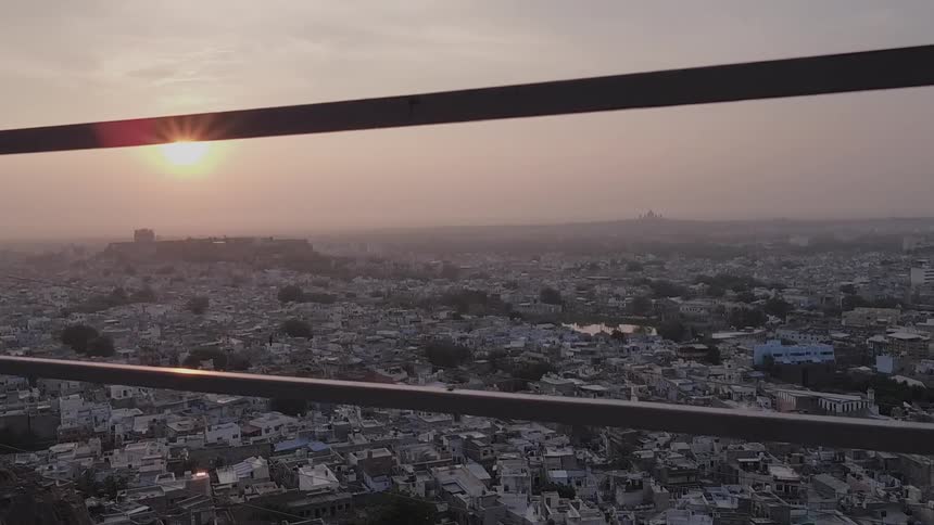 Large city spread out across the land at sunset