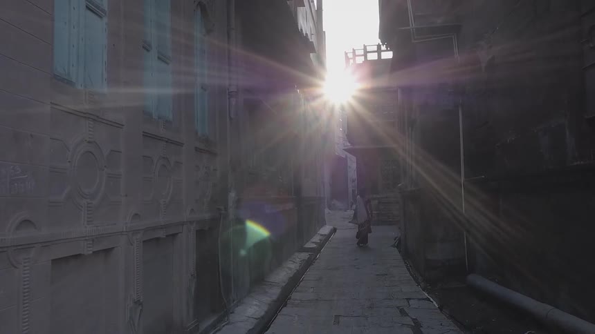 A person walks through an alley