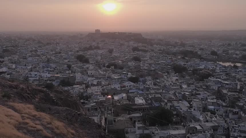 A large densely packed city is filmed from above