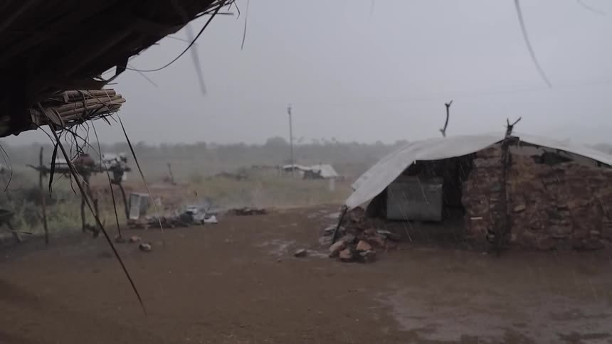 Rain is falling on buildings in a native village during the day