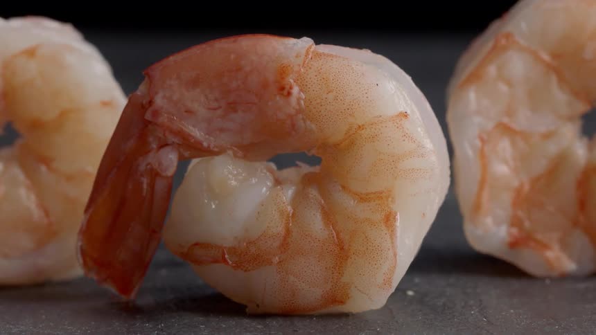 There are some shrimp rolled up being cooked