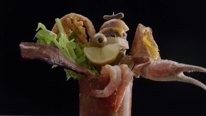 Seafood drink with shrimp celery gherkin and an olive