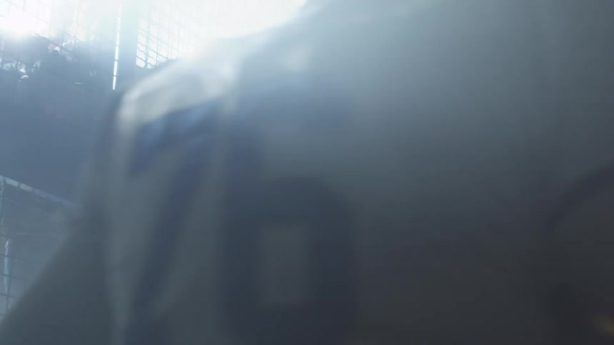 Football players running in the mist